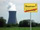 gefaktes Ortschild vor Kühlturm wirbt für Ökostrom statt Atomenergie