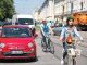 Radfahrer im städtischen Verkehr eingeklemmt zwischen Autos - Rückschritt bei der ökologischen Verkehrswende